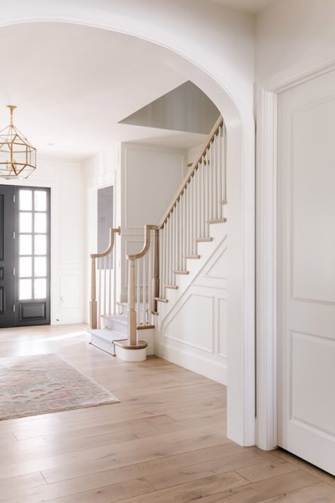 Modernize Colonial House Interior, White Walls Traditional Home, Modern French Country Front Door, Colonial Style Staircase, Stairs By Entryway, Modern Colonial Foyer, Stair Baluster Ideas Wood, Center Hall Colonial Staircase, Sandbar Oak Cali Bamboo