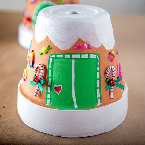 A terra cotta pot painted like a gingerbread house. Xmas Pots, Terracotta Christmas, Terra Cotta Pot Crafts Diy, Whimsical Christmas Trees, Senior Center, Terra Cotta Pot Crafts, Gingerbread Village, Christmas Pots, Pot Crafts