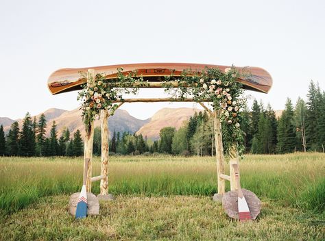 "We were married under a custom arbor of a canoe crafted by one of northern Montana’s most well-known canoe builders, Morley Canoes," the bride says. Canoe Wedding, Macrame Arch, Outdoorsy Couple, Rustic Style Wedding, Wedding Ceremony Arch, Wedding Ceremony Backdrop, Montana Wedding, Camp Wedding, Wedding Inspiration Summer