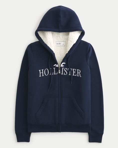 Women's Oversized Faux Shearling-Lined Logo Graphic Hoodie | Women's Tops | HollisterCo.com Graphic Embroidery, Hollister Hoodie, Top Graphic Tees, Sherpa Lined, Short Jacket, Oversize Hoodie, Logo Graphic, Zip Up Hoodie, Swimwear Accessories