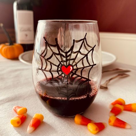 Halloween stemless wine glass hand painted with spiderweb with bright red heart in the center.    Spooky. Double painted and heat cured for durability.  Top rack dishwasher safe although I recommend hand washing for years of beauty.  Large capacity 21 oz to hold your favorite Halloween sprits.  5" tall, 3 1/2 " wide.  Gift box with hand written note card included. Spiderman Glass Painting, Halloween Painted Wine Glasses, Fall Wine Glass Painting, Halloween Wine Glasses Diy, Halloween Wine Glasses, Wine Glass Painting, Diy Wine Glasses, Autumn Wine, Halloween Wine