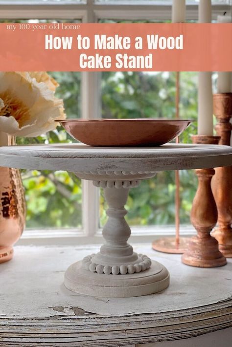 I love this wood cake stand so much. It was such an easy DIY and I think you might want to make one for sure! A few years I bought a wood cake stand that had beading and was painted white. I bought it at Magnolia in Waco and unfortunately they don’t sell it anymore. I get asked about the cake stand all of the time. So I decided to make one! The DIY How to Make a Wooden Cake Stand In the photo below, you can see the cake stand I bought at the Magnolia Market at the Silos. The… Wood Cake Stand Diy, Cake Stand Diy, Wooden Cake Stand, 100 Year Old Home, Diy Cake Stand, Farmhouse Projects, Wooden Cake Stands, Wood Cake Stand, Vintage Cake Stands