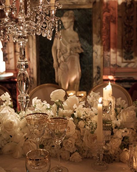 ✨ A wedding dinner fit for the gods, held in the truly opulent Apollo’s Muse ✨ Inspired by the elegance of Ancient Greece and Bacchus himself, indulgence flowed with prestige champagne at the wedding dinner of K + S. Bespoke cherub-themed menus echoed the venue’s classical grandeur, while the gold-gilded crockery elevated each toast and emulated the extravagance of the room. The high candles added to the atmosphere as flickering candlelight danced across white hues and marble details, crea... Tall White Candles, Gold Wedding Table Setting, Golden Table, Candlelit Wedding, Dinner Fits, Marble Detail, Wedding Table Settings, Wedding Dinner, White Candles