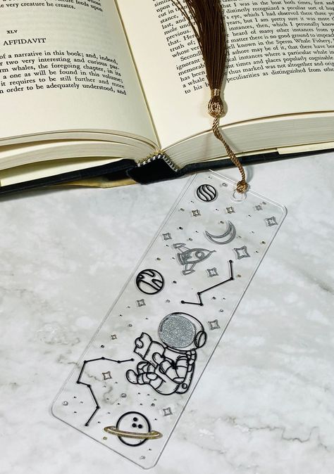 "Bookmark size is 2\" (W) x 6\" (L) A variety of designs to choose from! A great gift for anyone or just to add something special to your own book! We can even create a special and unique design just for you.  Don't forget to tag us!  If you share your band on Facebook, Instagram, or TikTok, Don't forget to tag us for a chance to be featured on our Instagram and Facebook page! Facebook: https://www.facebook.com/WhimsicalCraftCo Instagram: https://www.instagram.com/whimsicalcraftco/ TikTok: @MGZM Bookmark Size, Bookmark Stand, Solar System Bookmark, Bookmark Space, Planet Bookmarks, Space Bookmarks, Astronaut Bookmark, Space Themed Bookmark, Galaxy Bookmark Resin