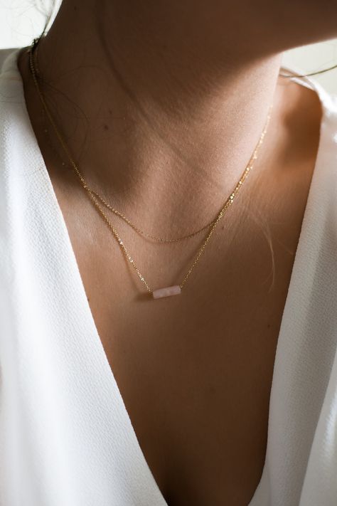 𝗘𝗮𝘀𝘆 𝗧𝗼 𝗦𝘁𝘆𝗹𝗲, 𝗠𝗮𝗱𝗲 𝗧𝗼 𝗟𝗮𝘀𝘁 Our dainty rose quartz gemstone necklaces are easy to layer and ready to be worn on repeat! Created to last a lifetime, these necklaces will remain evergreen even as the years and trends come and go. 𝗠𝗮𝘁𝗲𝗿𝗶𝗮𝗹𝘀 𝗪𝗲 𝗨𝘀𝗲 This necklace is made entirely with sturdy 14k yellow gold filled or sterling silver pieces and a genuine gemstone pendant. It is safe to wear in the shower, but we recommend avoiding prolonged exposure to chemicals like Delicate Gemstone Necklace, Rose Quartz Gold Necklace, Rose Quartz Necklace Beads, Silver Layering Necklaces, Rose Quartz Necklace Pendants, Dainty Rose, Rose Gold Quartz, Necklaces Pendant, Layering Necklaces