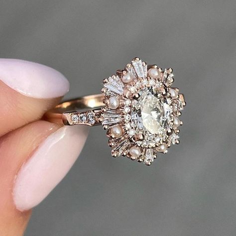 Custom Order For Melissa: 1.25CT Oval Moissanite Cluster Baguettes & Pearls Halo Moissanite Engagement Ring In 14K Solid Rose Gold By Moaana Jewel ♦ Stone: Moissanite ♦ Shape: Oval Cut ♦ Color: Colorless ♦ Main Stone Weight: 1.25 Carat  ♦ Main Stone Diameter: 8x6 mm  ♦ Side Stones: 0.59 CTW Round & Tapered Baguette Cut ♦ Side Stone Type: Created Pearls & Moissanite ♦ Clarity: VVS ♦ Crown Style: Halo/Double Halo ♦ Metal: 14K Solid Gold ♦ Metal Finish: Rose Gold ♦ Note: Plain Band ♦ Nickle Free ♦ Heidi Gibson, Halo Moissanite Engagement Ring, Cute Engagement Rings, Future Engagement Rings, Oval Moissanite, Plain Bands, Dream Engagement, Dream Engagement Rings, Jewelry Ring Box