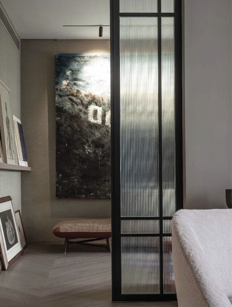 Designer Alfred Lam’s Hong Kong home reflects his belief that that the best designs often come from bringing together different eras. Beyond a fluted glass sliding door leading into the dedicated TV room is a large-scale painting by Chinese contemporary artist Li Qing above an ottoman by Hermès.  Design Anthology magazine 2019 Fluted Glass Sliding Doors, Sliding Door Aesthetic, Fluted Glass Partition Sliding Doors, Ribbed Glass Sliding Door, Fluted Glass Partition Living Room, Flute Glass Partition, Fluted Glass Sliding Door Kitchen, Flute Glass Door, Fluted Sliding Door