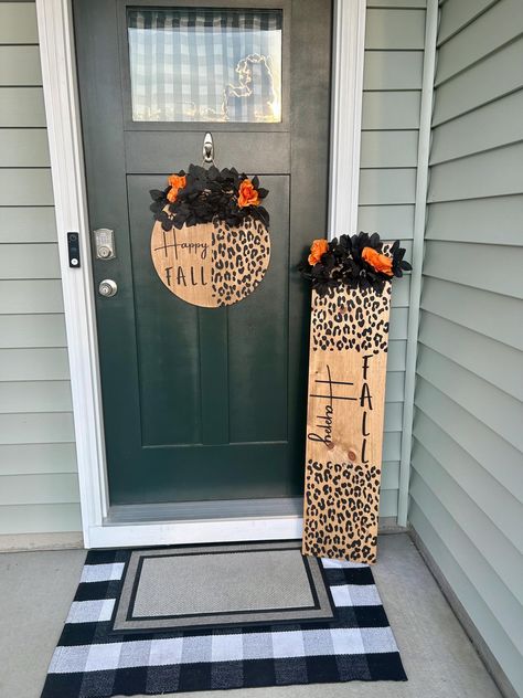 Matching Halloween door hanger and porch leaner. Both the door hanger and the learner are three-dimensional and cut with a laser. Each piece has a top coat  to give the wood lasting durability. This does best under a covered porch and without exposure to weather elements.  The leaner measures 48 inches long by 12 inches wide and the wood is pine. The door hanger is 18 inches in diameter and the wood is maple.  Shipping for the leaner is $20 and shipping for the door hanger is $8. They will both come in their own individually wrapped boxes.  Each piece is handmade to order so no two pieces are exactly the same. The door hanger and leaner have matching bows and greenery. ** BOW MAY NOT BE EXACTLY THE SAME AS PICTURE depending on ribbon availability. This duo is the  perfect way to welcome yo Door Leaners, Fall Welcome Sign, Porch Leaners, Door Hanger Fall, Americana Crafts, Halloween Door Hanger, Door Signs Diy, Halloween Door Hangers, Matching Halloween