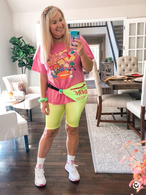 90’s party outfit with neon biker shorts, a Nickelodeon tee, fanny pack, butterfly clips, and chunky sneakers! Neon 90s Party Outfit, 90s Biker Shorts Outfit, 80s Bid Day Theme Sorority, Neon Roller Skating Party Outfit, 90 Theme Party Outfit, Lisa Frank Aesthetic Clothes, Lisa Frank Bid Day, Cheap 90s Party T-shirt, 90s Dress Up