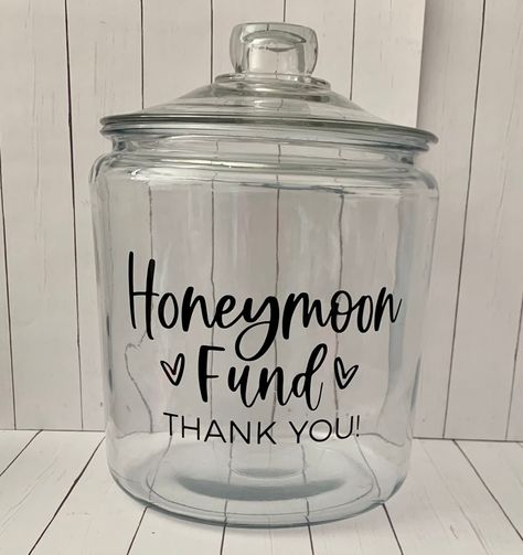 Honeymoon Fund Jar Decal, Wedding Shower Decal, Honeymoon Decal, Anniversary decal, Piggy Bank decal stickers, Travel decal, coin jar decal  Planning your honeymoon?!? Use this decal to put on a container to display at your wedding reception or wedding shower for your loved ones to help donate. Jar is not included.  This decal will say honeymoon fund thank you and come with hearts.  Message me the color vinyl decal you want. If I don't have a message with your order with color I will send black. Honeymoon Fund Jar, Honeymoon Shower, Coin Jar, Wedding Fund, Cricut Wedding, Honeymoon Fund, Wedding Activities, Future Wedding Plans, Cute Wedding Ideas