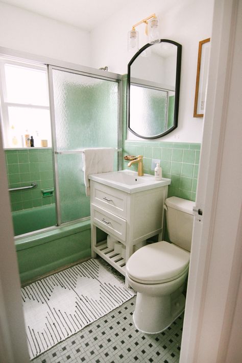 When we bought this home, I knew that the mint tile was here to stay. I also knew it couldn’t stay as-is – the sink was super retro and scalloped, and made the bathroom feel dingy and outdated. I wanted to brighten up the space by painting it white, and adding in an updated and more modern feeling white vanity. I was so excited to partner with Wayfair to find everything, including this gold faucet which is now my pride and joy!   To start, we ripped out the old vanity, mirror and light fixtur... Green Tile Bathroom, Mid Century Bathroom, Retro Bathrooms, White Appliances, Room Remodel, Vintage Bathrooms, After Pictures, Bathroom Update, Bathroom Redo