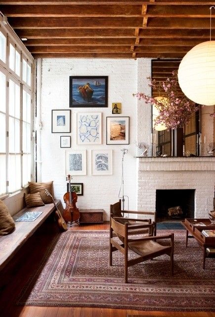 3/4 height windows, oriental rug, minimalist chairs, modern chandelier, large mirror on mantle, exposed ceiling joists, gallery wall Mill Work, Cleveland Rocks, House Vibes, Ideas Hogar, Painted Brick, Persian Rugs, A Living Room, A Fire, Cheap Home Decor