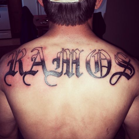 Last name tattoo, old English tattoo Old English Back Tattoo, Last Name On Back Tattoo, Shoulder Name Tattoo, Name Tattoos On Back, Last Name Tattoos, Old English Tattoo, Tattoo Font For Men, Name Tattoos On Wrist, Tattoo Sites