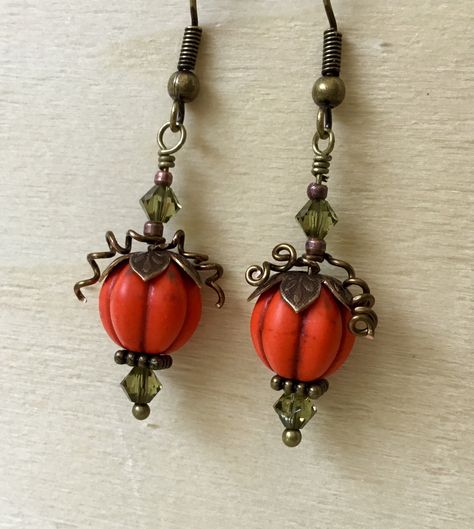 Autumn Halloween Pumpkin Fall Bead Earrings with Swarovski Crystals 🎃 ~Bright Detailed Pumpkin Bead with etched Brass findings and Wire Vine accents  ~Swarovski Olive Crystal jewels  ~2" (6cm) Drop length Easy on French Shepherd Hooks with rubber stopper backing *Antique Brass hooks OR *Hypo Titanium (Silver Tone) Metal Safe hooks  20-21 gauge Makes a unique Trick or Treat gift ! Please contact with any questions you may have 💎 CHECK OUT GlassSlippersCC Shop for more Crystal Creations 💎  SOCI Halloween Pumpkin Patch, Crochet Metal, Fall Bead, Pumpkin Bead, Glass Slippers, Pumpkin Earrings, Brass Hook, Fall Earrings, Earrings Inspiration