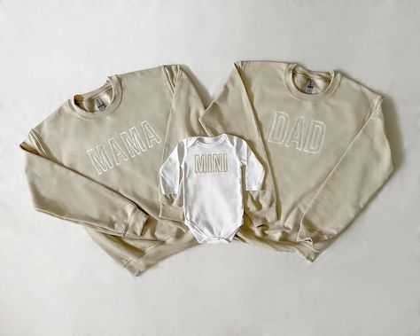 "Each piece is sold separately. These unique embroidered beige and white mama, dad and mini sets for moms and babies and toddlers make for the cutest photos and memories! Each trendy sweatshirt (or bodysuit) is made to order and is perfect for everyday fun as well as baby shower gifting. We also offer custom orders, so feel free to shoot us a message! Our \"mama\" and \"dad\" embroidered sweatshirts come in beige with white lettering and our baby bodysuits and toddler sweatshirts come in white w Mommy And Me Sweatshirt, Family Matching White Sweatshirt With Letter Embroidery, White Family Matching Sweatshirt With Letter Embroidery, Cream Cotton Top With Letter Embroidery, Cream Cotton Tops With Letter Embroidery, Mom And Dad Sweatshirts, Beige Mom, Cute Pregnancy Pictures, Mom Things