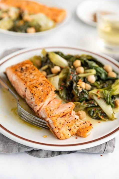 Pan-fried Salmon with Braised Escarole and Chickpeas is a quick and easy midweek lunch or dinner recipe, made in just 30 minutes. The salmon fillets are perfectly cooked, with a crispy skin and the escarole is creamy and delicious. #dinnerecipes #healthydinner #lowcarb #glutenfreerecipes #panfriedsalmon #escarole Braised Escarole, Best Fish Recipes, Pan Fried Salmon, Fried Salmon, Winter Dishes, Shellfish Recipes, Winter Dinner, Fish And Meat, Salmon Fillets