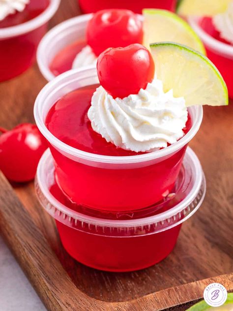 These Dirty Shirley Jello Shots are a fun and tasty twist on classic jello shots. Made with cherry jello, lemon-lime soda, grenadine, and vodka, they taste just like a boozy Shirley Temple drink. They’re so easy to make for your next get together! Crazy Cocktails, Cherry Jello Shots, Jello Shots Vodka, Shirley Temple Drink, Dirty Shirley, Cranberry Jello, Jello Flavors, Bachelorette Drink, Frosted Lemonade