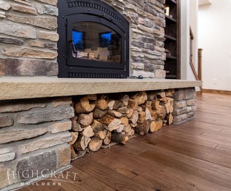 As Haley mentioned in Part 1, “We’re swimming in firewood,” and they use a wood-burning fireplace insert to help heat their home. Below the fireplace, a clever wood storage solution was created under the stone hearth. Wood Stove Surround With Wood Storage, Wood Burn Fireplace, Wood Storage Under Wood Stove, Wood Burning Stone Fireplaces, Brick Fireplace With Log Storage, Stacked Stone Fireplace Cabin, Wood Fireplace Wood Storage, Wood Fireplace Storage, Wood Burning Fireplace With Wood Storage