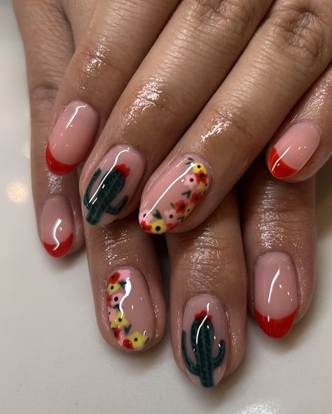 Some cute Cinco de Mayo themed nails! Something unique and easy to rock in the May month!! Love how these turned out. #manicure #nails #frenchnails #maynails #gelx #roundnails #redtips #cutenails #cincodemayo #nailinspo #beauty #thegelbottle #springnails #nailtrends #cactus #cactusnails #floralnails Fall Mexico Nails, Mexican Design Nail Art, Mexican Independence Nails, Mexico Holiday Nails, Texas Nail Ideas, Latin Nail Designs, Cactus Nail Ideas, Mexican Flag Nails Designs, Mexican Christmas Nails