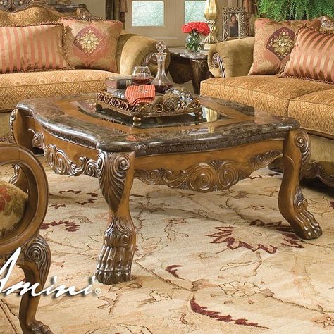 The Garden of Eden is often thought of as Paradise, and as such, is an apt name for this collection from the Michael Amini Original Furniture Designs. The Eden Occasional Table Collection brings the flair of European "Old World" styling, and ties it all together by featuring a Lion's paw motif. It is beautifully crafted in Birch solids and veneers, with inlays of Ash Burl that are able to show off the exquisite details of the pieces. Dramatic intricate carvings are found throughout the ... Wooden Living Room Table, Michael Amini Furniture, Mansion Palace, Living Room Table Set, Glamorous Living, Wooden Living Room, King Size Beds, Michael Amini, Traditional Living Room Sets