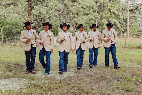 Classically handsome western attire adorn these six groomsman at a western themed wedding in Pagosa Springs, Colorado at the Paradise Ranch wedding venue surrounded by pine and aspen.  The western boots, jeans, beige western cut jacket and black felt cowboy hats are stunning together for this natural easy going western wedding.  To see more of this wedding go to www.paradiseranchevents.com Coral Western Wedding, Western Groomsmen Attire, Western Wedding Groomsmen, Classy Western Wedding, Groomsmen Jeans, Country Groomsmen, Country Wedding Groomsmen, Groomsmen Dress, Pagosa Springs Colorado