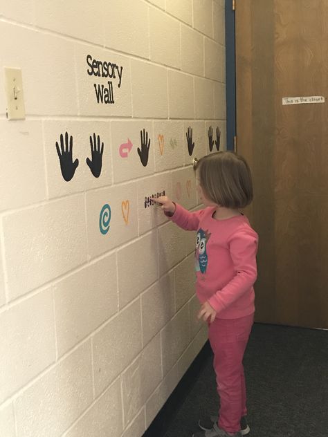 Sensory wall in kindergarten classroom Sensory Path In Classroom, Preschool Corridor Decor, Sensory Wall Classroom, Wall Sensory Activities, Sensory Wall Ideas Classroom, Kindergarten Hallway, Sensory Trail, Sensory Walk, Sensory Classroom