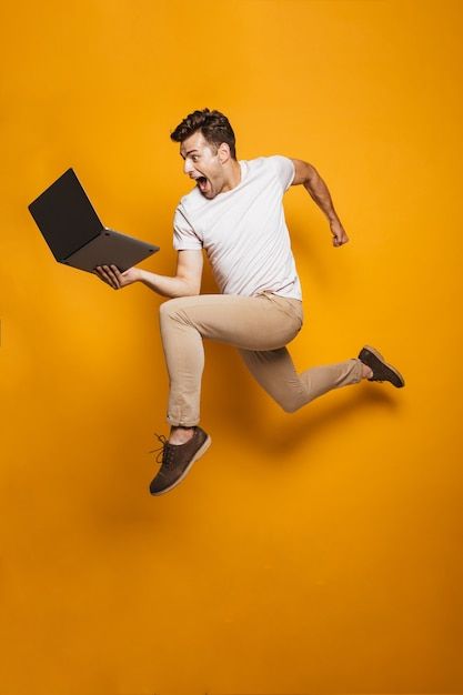 Photo full length portrait of a happy yo... | Premium Photo #Freepik #photo #guy-with-laptop #man-jumping #man-laptop #happy-man Person Png, Man Jumping, Happy Images, Yellow Background, Premium Photo, Images Photos, Royalty Free Images, Full Length, Stock Images