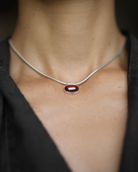 NEW Oval Garnet Necklace Handmade solid sterling silver necklace featuring a hessonite garnet pendant. The oval translucent cinnamon red garnet cabochon is bezel set and glides freely along the sleek snake chain. Hessonite garnet is 14mm in length, app. 7cts, and ethically sourced. Necklace is 40cm in length but it can be customized according to your preferences. Available at mirtajewelry.com Cinnamon Red, Hessonite Garnet, Garnet Pendant, Garnet Necklace, Red Garnet, Necklace Handmade, Sterling Silver Necklace, Snake Chain, Bezel Setting