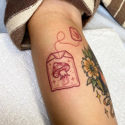 Cute mushroom tea bag #redinktattoo #redtattoo #mushroom #mushrooms🍄 #mushroomtattoo #tattoo #tattooartist #art #tea #teabag… | Instagram Cute Fire Tattoo Ideas, Ankle Tattoo Mushroom, Red Ink Mushroom Tattoo, Traditional Style Mushroom Tattoo, Mushroom Cow Tattoo, Minimal Tattoo Designs Unique, Mushroom Fairy House Tattoo, Cute Mushroom Tattoo Ideas, Bobs Burger Tattoo Ideas