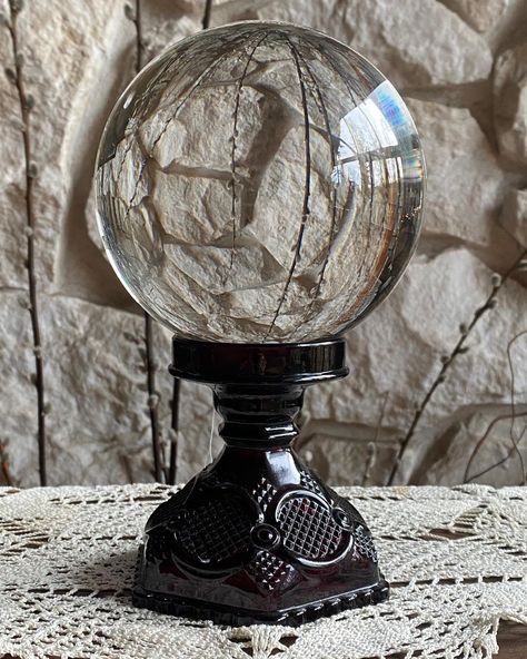 $140 (SOLD) Gorgeous Sphere & Stand. Amazing combination. Stand is 4 1/2 inches tall and the base is 5 inches in diameter. The sphere (reconstituted quartz) measures 6”, it’s VERY large and is especially alluring when it reflects a patterned backdrop. The stand is Ruby Glass, dark deep red. #ruby #rubyred #crystalball #witchdecor #crystalball #altarspace #invoke Crystal Orb, The Stand, Witch Decor, Red Ruby, Red Glass, Crystal Ball, Deep Red, Artifacts, Ruby