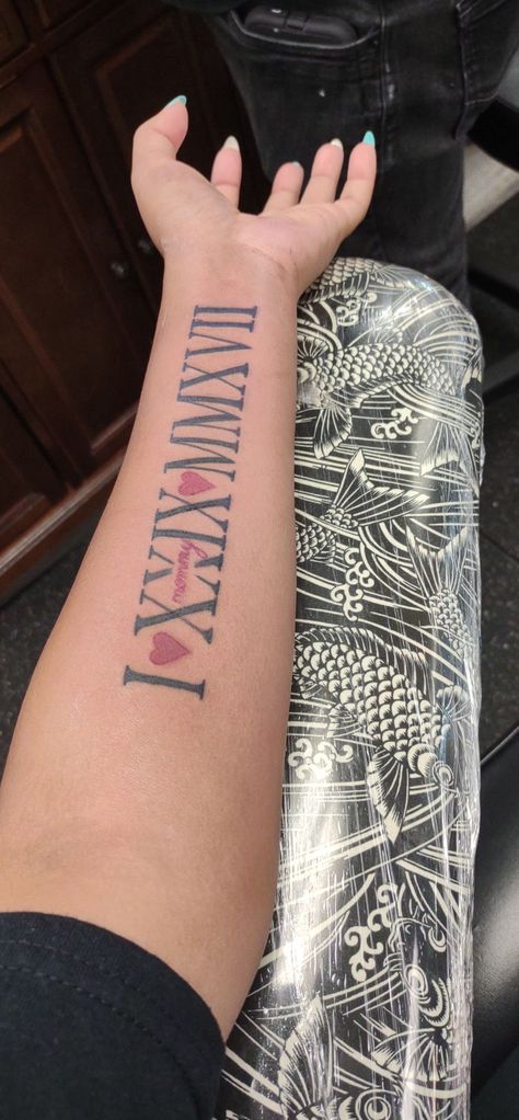 Red And Black Roman Numeral Tattoo, Tattoo Ideas Numbers Roman Numerals, Roman Numeral Tattoo Inner Arm, Roman Numeral Tattoo On Arm, Numeral Number Tattoo, Arm Tattoos For Women Forearm, Side Arm Tattoos, Cute Thigh Tattoos, Inner Arm Tattoos