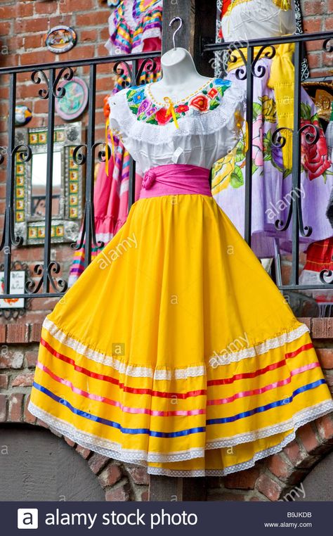 Download this stock image: A traditional Mexican peasant dress hanging outside of a clothing store on Olvera Street, Los Angeles, California - B9JKDB from Alamy's library of millions of high resolution stock photos, illustrations and vectors. Olvera Street Los Angeles, Traditional Mexican Clothing, Folklorico Dresses, Olvera Street, Mexican Skirts, Mexican Clothing, Traditional Mexican Dress, Mexican Fashion, Mexican Outfit