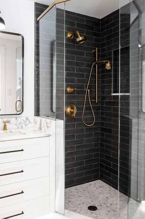 Bathroom features black brick style shower tiles that boast a brushed gold shower kit and light gray marble hexagon floor tiles. Black Hexagon Shower Floor, Hexagon Shower Floor, Hexagon Floor Tiles, Navy Blue Shower Curtain, Brick Bathroom, Grey Mosaic Tiles, White Hexagon Tiles, Tweed Design, Hexagon Tile Floor