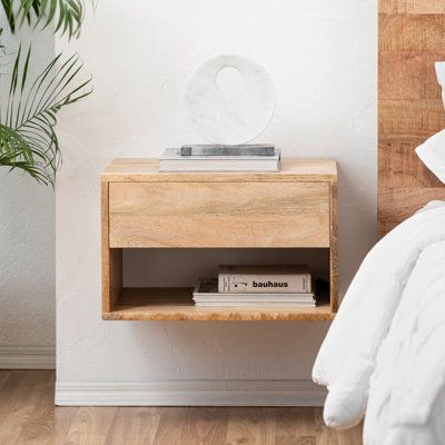 Floating Functionality! A space-saving solution for your everyday - meet this floating nightstand. Kiln-dried solid wood all over, the natural variations of the grains give it a rich character. Designed with a handleless drawer and a shelf underneath, styling and storage are intentionally made easy. Its off-the-floor design provides plenty of room for movement. And the clean, seamless form - so Scandi! Color: Natural | AllModern Kailey Solid Wood Floating Nightstand Wood in Brown | 12.5 H x 20 W Floating Nightstand Diy, Floating Bedside Shelf, Nightstand Brown, Floating Nightstands, Scandi Bedroom, Rich Character, Floating Bedside Table, Floating Shelves Bedroom, Nightstand Wood