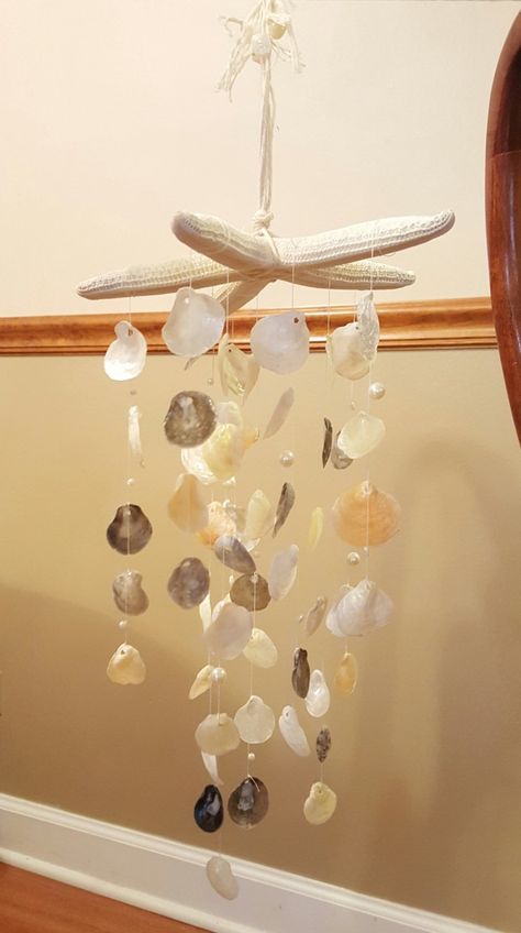 "A 6-8\" starfish, with jingle shells and beads hanging from it to create a pretty,delicate windchime. Relax to the jingle of this windchime. Colors may vary" Seashell Suncatcher Diy, Seashell Chimes, Seashell Coasters, Jingle Shells, Shell Hanging, Shell Creations, Shell Projects, Seashell Wind Chimes, Wind Chimes Homemade