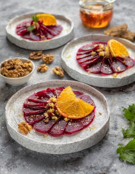 Savor the vibrant colors and fresh flavors with this Beet Carpaccio with Orange Vinaigrette, an elegant starter that pairs the earthy sweetness of beets with a zesty orange dressing. Topped with toasted walnuts, this dish offers a delightful crunch and nuttiness that complements the soft texture of the beets perfectly. Beet Salad Plating, Beetroot Carpaccio Fine Dining, Beetroot Canapes, Vegan Fine Dining Dishes, Cold Starters Fine Dining, Vegetarian Carpaccio, Veggie Carpaccio, Beets Appetizer, Colorful Appetizers