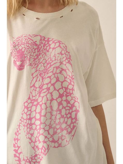 Color: Ivory Vintage-Style Cheetah Graphic Print in Pink Distressed, Garment Washed Round Neckline Short Sleeves Dropped Shoulder Torn And Distressed Detailing At Neckline, Cuffs, And Hem Oversized Fit 100% Cotton Model: Height- 5'9"/ Bust- 31in / Waist- 23in / Hips- 33in and is wearing a SMALL