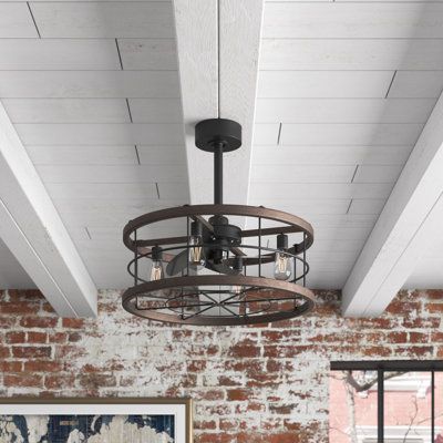 This ceiling fan fuses a sleek, modern silhouette with industrial and rustic elements for a standout look. It features an open, drum-shaped metal frame with a matte black finish while wooden borders add subtle contrast. Three central blades along with a fixture for four downward-facing E26 socket bulbs (not included) fit in the middle. It also comes with a remote to control the three-blade speeds and the lights. It hangs from a canopy that's compatible with rooms that have sloped ceilings. Plus, Coastal Ceiling Fans With Lights, Caged Ceiling Fan, Farmhouse Ceiling Fan, Coastal House, Wheel Chandelier, Remote Control Light, Black Ceiling Fan, Ceiling Detail, Upstairs Bedroom