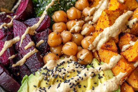 Enjoy a wholesome roasted beet and sweet potato Buddha bowl with avocado, chickpeas, and lemon-tahini dressing. Perfect for a healthy and balanced meal! Roasted Beet And Sweet Potato Budda Bowl, Sweet Potato Buddha Bowl, Potato Buddha Bowl, Chickpeas Recipe, Sweet Potato Bowls, Buddha Bowls Recipe, Lemon Tahini Dressing, Chicken Sweet Potato, Chickpea Recipes