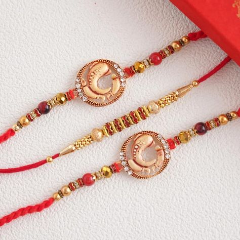 Send Splendid set of 3 divine golden Rakhi Online | Rakhibazaar.com Handmade Rakhi Designs, Rakhi Online, Handmade Rakhi, Rakhi Design, Black Beads Mangalsutra, Ganesh Statue, Raksha Bandhan, Thread Work, Silk Thread