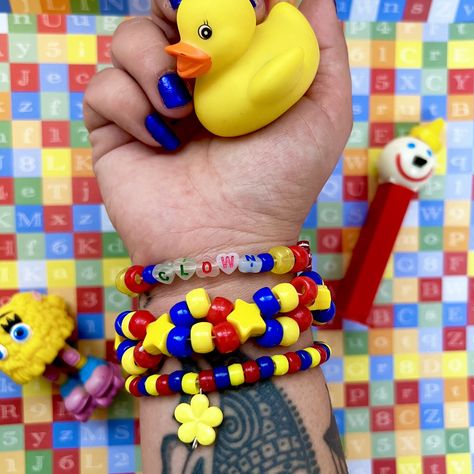 Handmade primary color clown theme Kandi bracelet cuff set of 3  With alphabet beads "clown" and yellow flower charm  *clown letter beads and charms may differ slightly * One size fits most ( approximately 6-7 in) Tags; clown clowncore kandicore clown town kidcore rave accessories jewelry Y2K weird weirdcore Clowncore Kandi Bracelets, Clown Bracelet, Clowncore Kandi, Clown Kandi, Kandi Accessories, Pony Beads Bracelet, Kandi Charms, Kidcore Accessories, Clown Theme