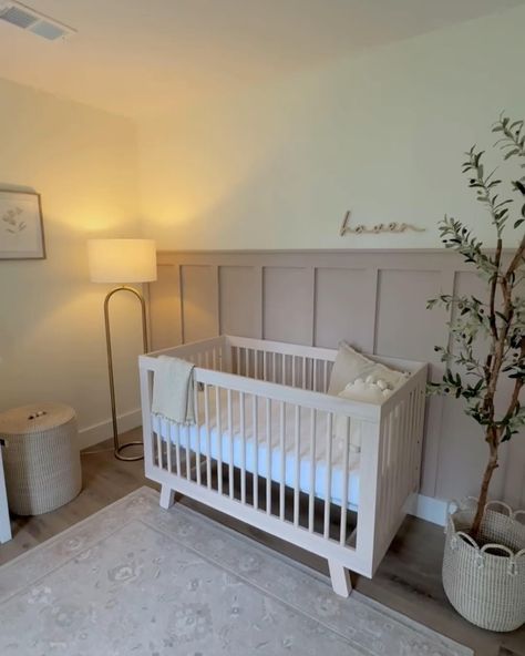 Thrilled to share a peek into this beautiful girl’s nursery featuring our custom wooden name sign above the crib! Interested in adding a personal touch to your nursery? Message me today to create your custom sign! Nursery design by @melissaaderue #NurseryDecor #BabyGirl #CustomSigns #NurseryInspo #HandcraftedWithLove #nurserynamesign #namesign #namesigns Wood Panel Accent Wall Nursery, Half Wall Paneling Ideas Nursery, Nursery Accent Wall Wood, Nursery Wall Molding, Wainscoting Nursery Girl, Half Wall Nursery, Wood Accent Wall Nursery, Nursery Wall Paneling, Board And Batten Nursery Wall