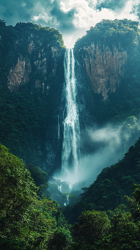 The towering Angel Falls cascading through lush green forest under a clear blue sky. Angel Waterfall, Travel Wallpaper Aesthetic, Angel Falls Venezuela, Unique Vacation Rentals, Angel Falls, Tropical Forests, Unique Vacations, Destin Hotels, Family Friendly Hotels