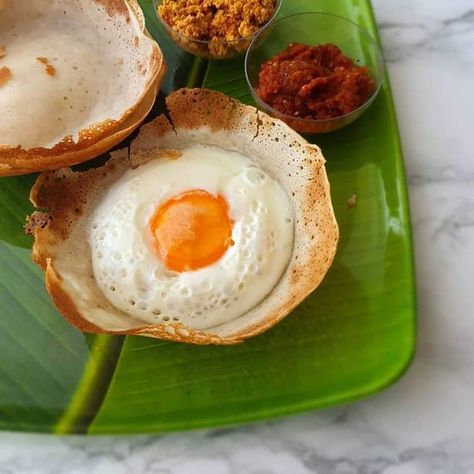 Hoppers and egg hoppers are iconic dishes in Sri Lankan cuisine, deeply rooted in tradition and flavor. Hoppers are bowl-shaped pancakes made from a fermented batter of rice flour, coconut milk, and a dash of sugar. They are typically cooked in a small, round pan and are enjoyed at any time of day, from breakfast to dinner. Egg hoppers are a variation where an egg is cracked into the center of the hopper as it cooks, creating a delicious combination of textures and flavors. The result is a ... Egg Hoppers, Shaped Pancakes, Sri Lankan Food, Sri Lankan Recipes, Mouthwatering Food, Street Vendor, Quick Snack, Hearty Meal, Rice Flour