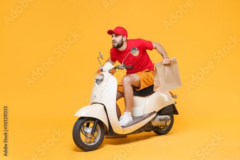 Stock Image: Delivery man in red cap t-shirt uniform driving moped motorbike scooter hold craft paper packet with food isolated on yellow background studio Guy employee working courier Service quarantine concept T Shirt Uniform, Delivery Boy, Background Studio, Boy Pic, Flyer Design Inspiration, Cover Art Design, Red Cap, Courier Service, Craft Paper