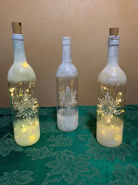 Wine Bottle Xmas Crafts, Lighted Liquor Bottles, Wine Bottles Crafts, Holiday Wine Bottle Crafts, Empty Wine Bottle Crafts, Spray Painted Wine Bottles, Decorated Wine Bottles, Bottle Fairy Lights, Fall Wine Bottles