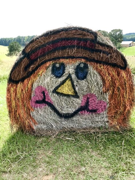 Fall 2018 Scarecrow Round Hay Bale Painted Round Hay Bales, Fall Painted Round Hay Bales, Fall Hay Bale Painting, Fall Haybale Decorating Ideas, Thanksgiving Hay Bale Decorations, Pumpkin Hay Bale Display, Hay Bale Art Round, Painted Hay Bales Halloween, Fall Haybales