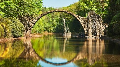 Devil's Bridge, known in German as Rakotzbrücke, is located within Germany's Azalea and Rhododendron Park Kromlau. Germany Landscape, Germany Poland, Perfect Circle, Arch Bridge, Medieval Town, A Perfect Circle, Germany Travel, Travel Dreams, Europe Travel