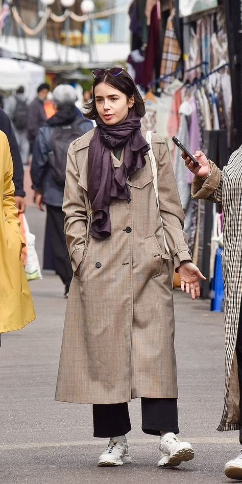 Emily in... Shepherd's Bush Market! Makeup free Lily Collins looks effortlessly chic in a trench coat and shades as she buys special souvenir for husband during London outing | Daily Mail Online Lily Collins And Her Husband, Lily Collins Street Style, Wide Legged Trousers, Louisiana Bayou, Burgundy Scarf, Brown Trench Coat, Shepherds Bush, Makeup Free, Black Wide Leg Trousers