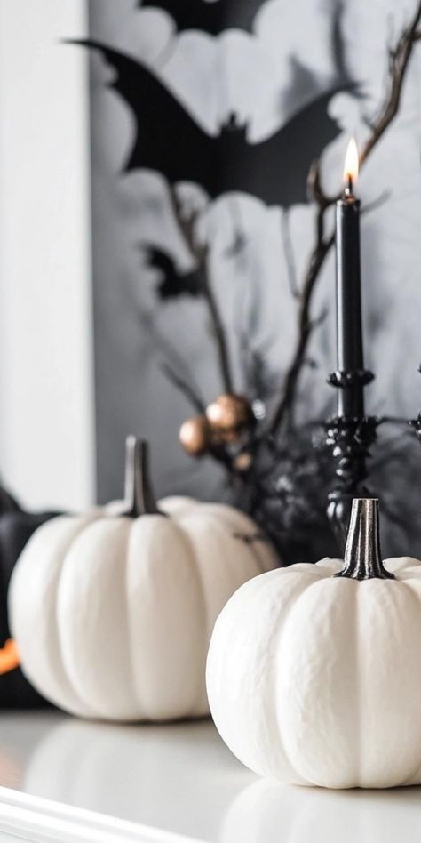 Create a hauntingly beautiful space with minimalist Halloween decor. Focus on negative space and strategic placement of a few key pieces. Display a collection of white pumpkins in varying sizes, or hang a simple wreath made of black twigs. Use lighting to cast eerie shadows, creating atmosphere without clutter. Incorporate subtle nods to Halloween with geometric ghost-shaped vases or sleek candleholders. This refined approach allows for a sophisticated celebration of the spooky season that's bot Minimalist Halloween Decor, Black White Halloween, Simple Wreath, Decor For Halloween, Minimalist Halloween, Party Styling, White Halloween, Hauntingly Beautiful, To Cast